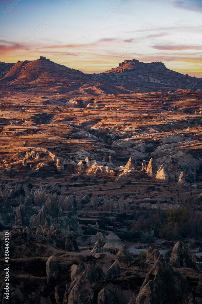 Stunning view of some rock formations in the Red & Rose Valley in Cappadocia during a beautiful sunrise. Goreme, central Anatolia, Turkey