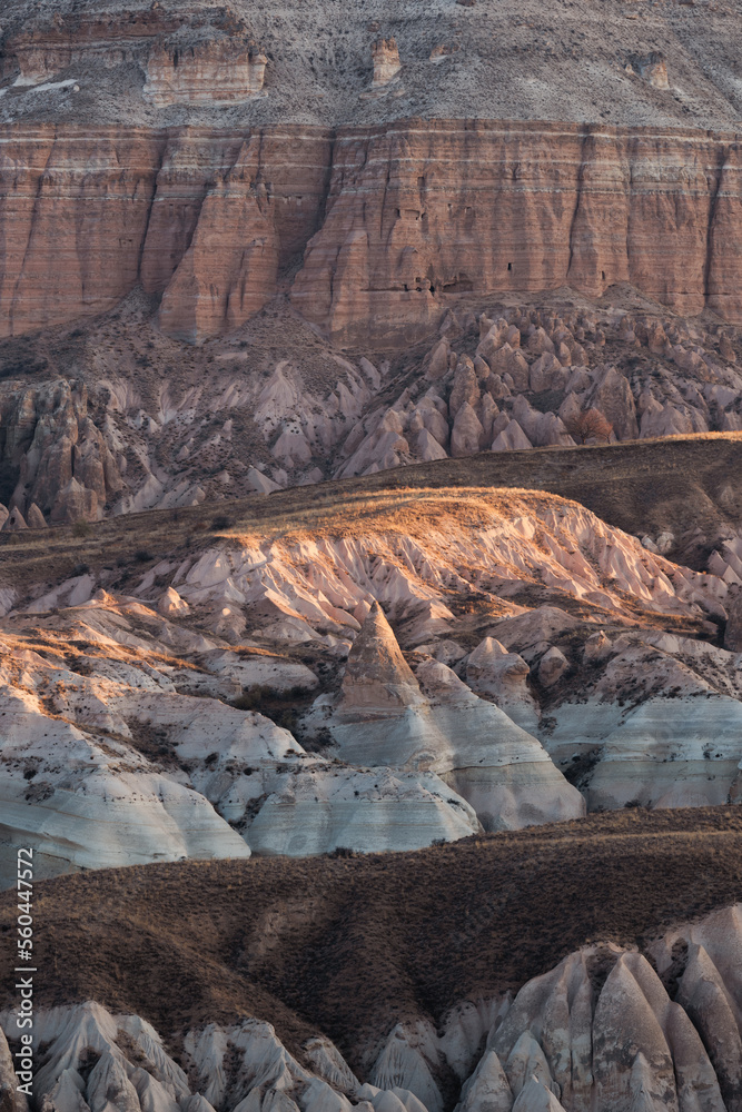 Stunning view of some rock formations in the Red & Rose Valley in Cappadocia during a beautiful sunrise. Goreme, central Anatolia, Turkey