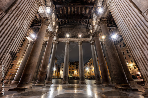 View of the empty Rotonda Square  Piazza della Rotonda  between the ancient columns of Pantheon in Rome in dark hours before sunrise  Italy