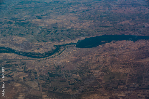 Aerial landscape view of area around the City of Sennar in Sudan, Africa with the Sennar Dam located in the river course of Blue Nile. The Town is surrounded by large agricultural fields 