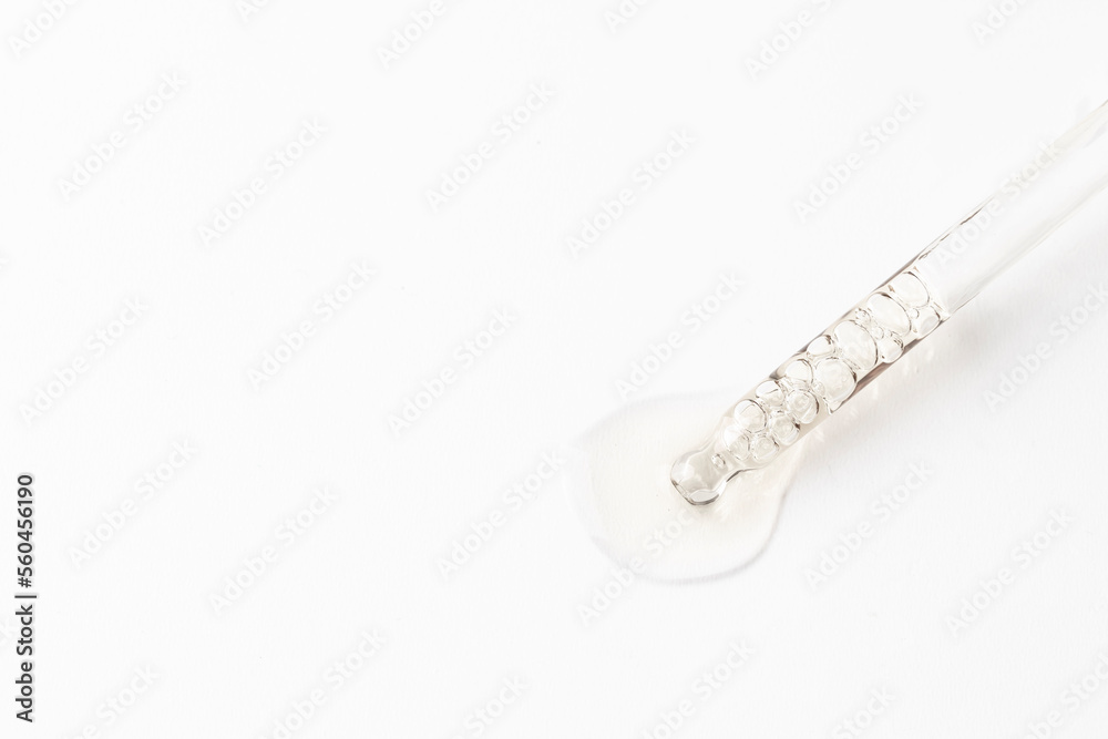 Dropper pipette with trasparent liguid on white background .Cosmetic product, science and research concept Dropper pipette with trasparent liguid on white background .Cosmetic product, science and research concept