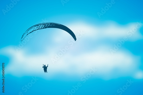 paragliding adventure paraglider in blue cloudy sky
