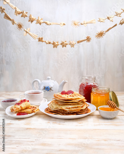 Pancakes, teapot, honey and jam on wooden table. Pancake week. festive traditional slavic tasty for Maslenitsa holiday. 