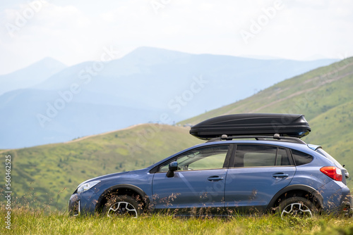 Blue off road car on mountain trail. Traveling by auto  adventure in wildlife  expedition or extreme travel on SUV automobile