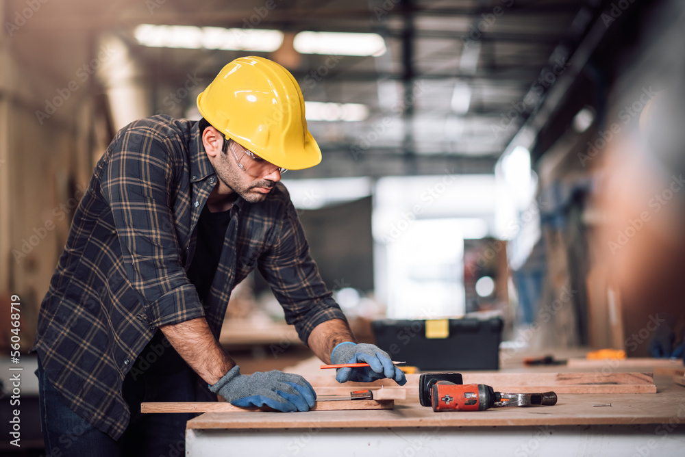 Young adult men carpenter craftman working in small business wood workshop. Timber industry and furniture industry. Young adult men carpenter craftman working in small business wood workshop. Timber industry and furniture industry.
