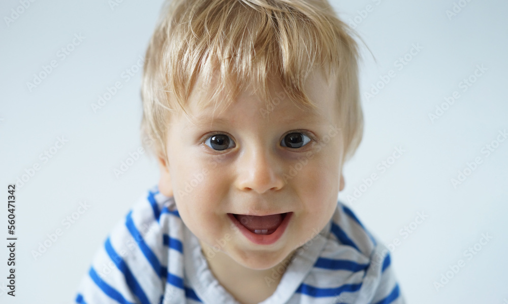 Little, happy and smiling cute baby in the studio. Portrait of a one year old baby. The concept of happiness. Little, happy and smiling cute baby in the studio. Portrait of a one year old baby. The concept of happiness.