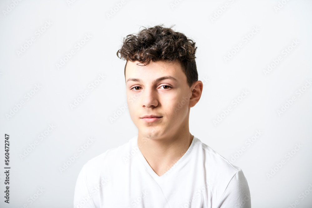White t-shirt on teen boy. Handsome caucasian isolated on a white background White t-shirt on teen boy. Handsome caucasian isolated on a white background