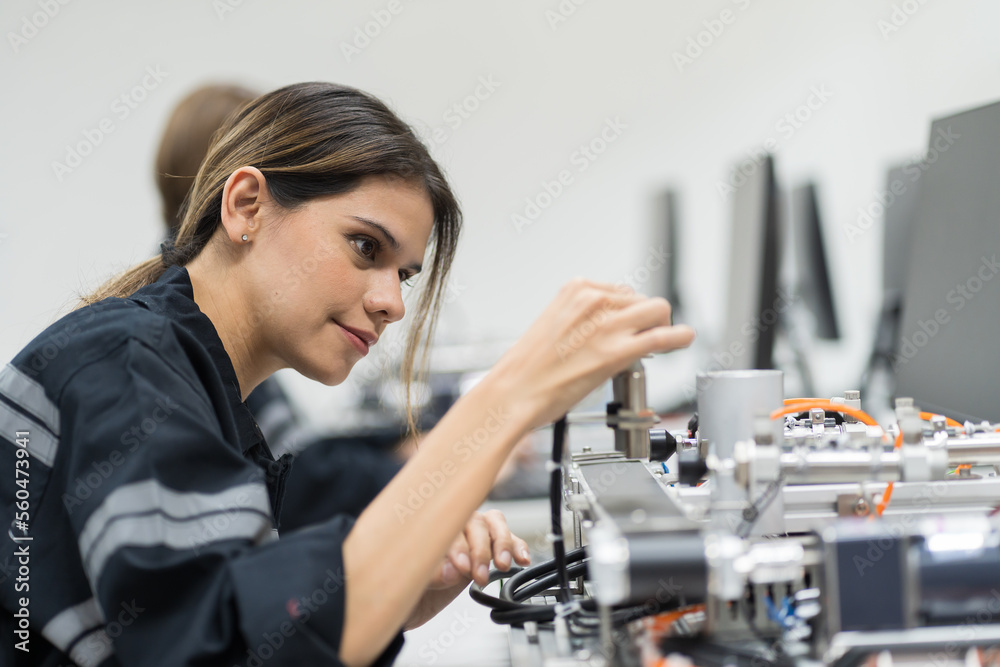 Female engineer training AI robot training kit and mechatronics engineering in the manufacturing automation and robotics academy room Female engineer training AI robot training kit and mechatronics engineering in the manufacturing automation and robotics academy room