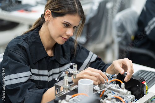 Female engineer training AI robot training kit and mechatronics engineering in the manufacturing automation and robotics academy room photo