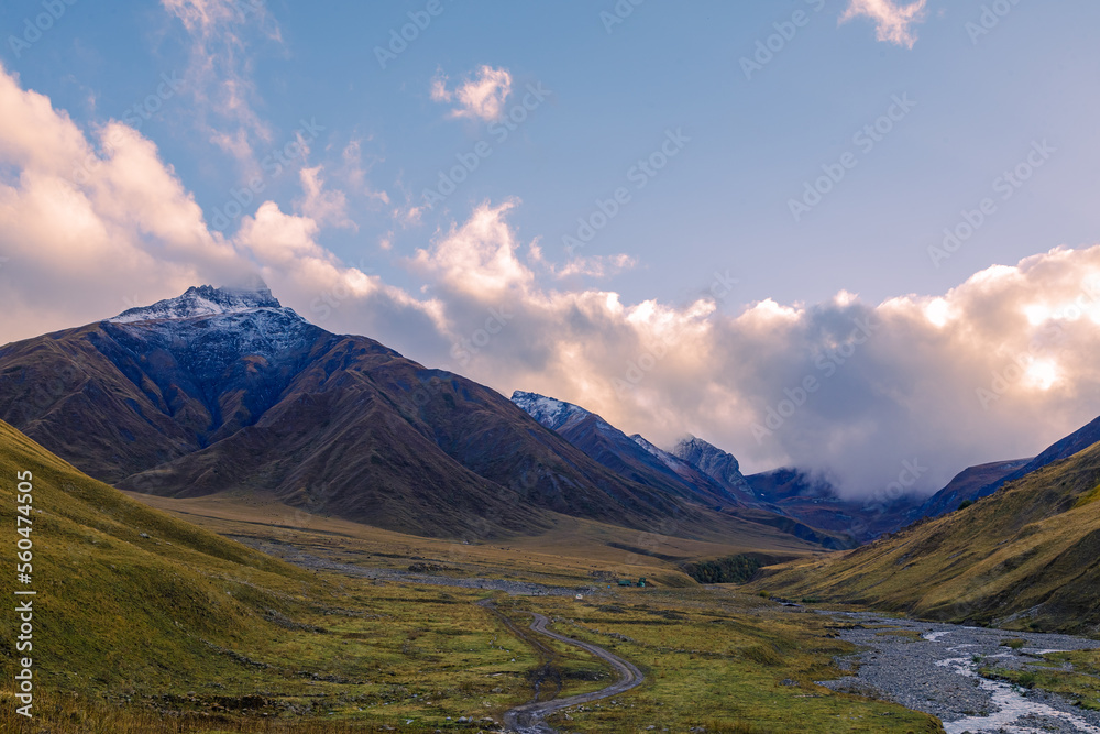 Highlands of North Ossetia. Mountains of the Caucasus. High mountains in the rays of the setting sun