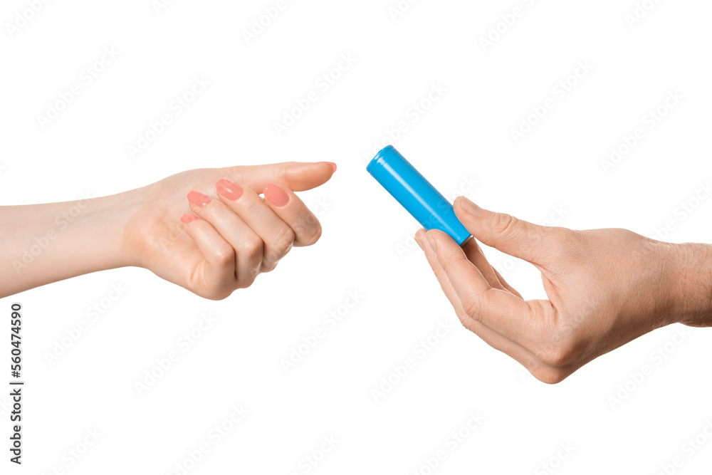 Rechargeable battery offer from a male hand to a female, isolate on a white background. Rechargeable battery offer from a male hand to a female, isolate on a white background.