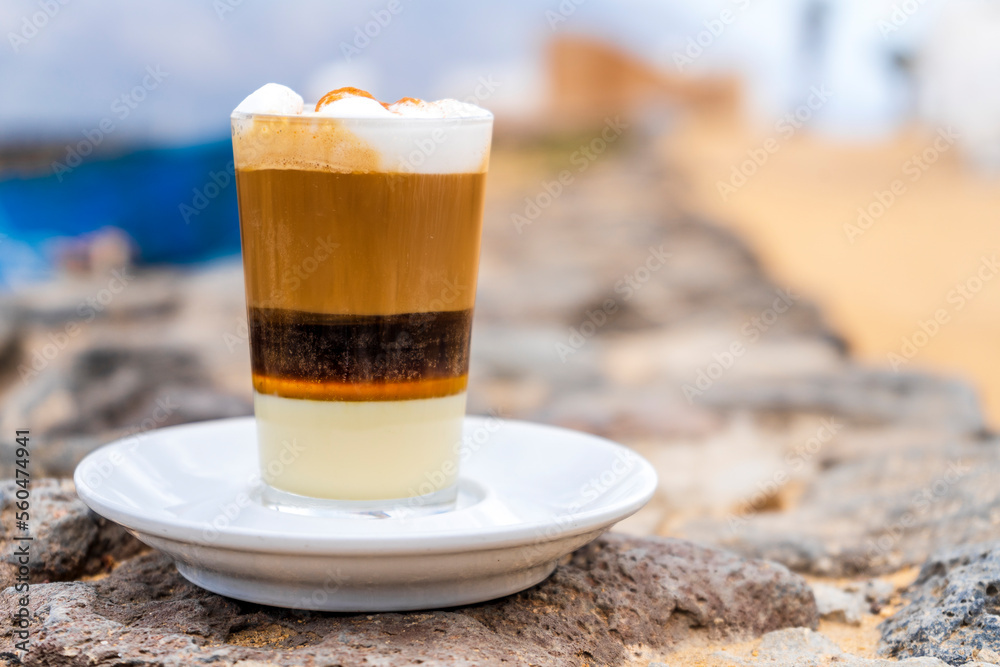 Delicious barraquito coffee with liquor and condensed milk, typical for Canary Island, Spain