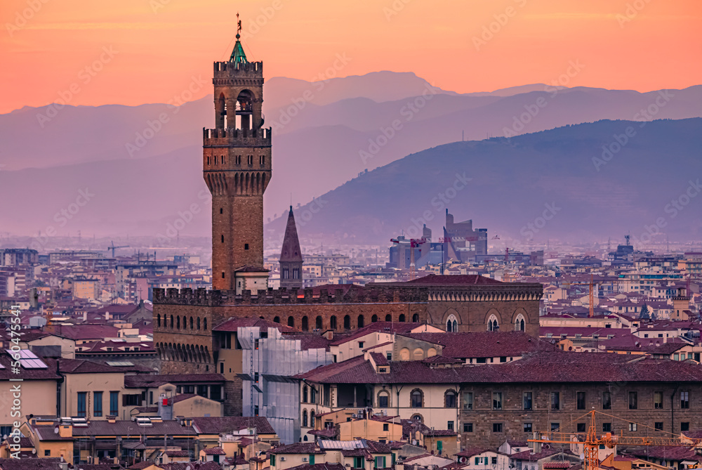 View of the famous Palazzo Vecchio Tower and Florence cityscape in Florence, Italy in a colorful sunset, aerial view at night