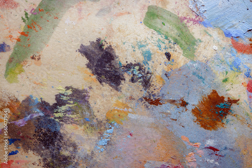 Colorful abstract texture. Smears of oil paint on an art palette. The concept of the modern school of art. Fragment of creative work. Colors of the year 2023.