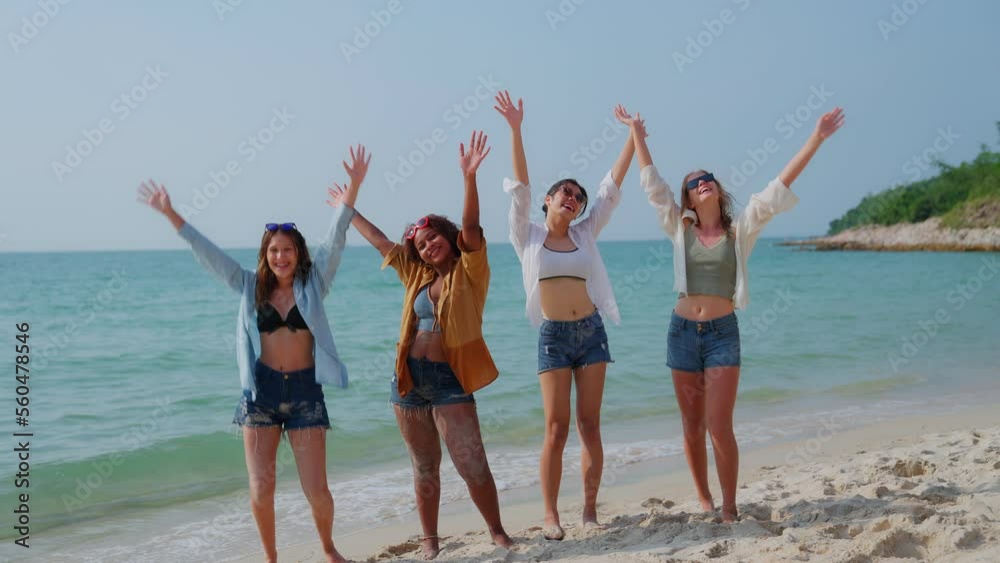 Group of multi ethnic teenage girls holding rubber ring on the beach. Friends are happy, relaxing, jumping and throwing rubber ring into the sky. Happy female on summer vacation time on the weekend. Group of multi ethnic teenage girls holding rubber ring on the beach. Friends are happy, relaxing, jumping and throwing rubber ring into the sky. Happy female on summer vacation time on the weekend.