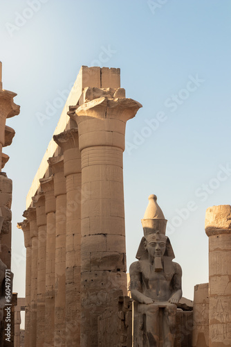 Vertical view of the entrance of luxor temple in Egypt. Clear blue sky with big cloumns and statue in egyptian architecture