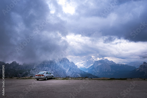 Car in Mountains with stormy clouds