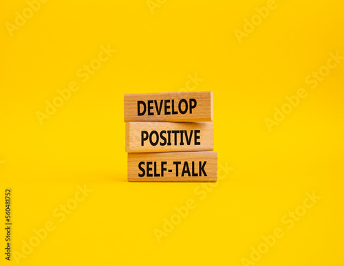 Develop positive self-talk symbol. Concept words Develop positive self-talk on wooden blocks. Beautiful yellow background. Business and Develop positive self-talk concept. Copy space