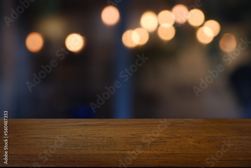 Empty wooden table in front of abstract blurred Cafe  restaurant at night. For montage product display or design key visual layout - Image
