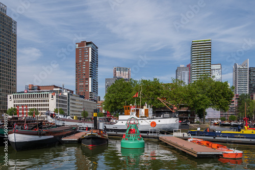 Outdoor sunny view surround with boats and ships at pier around leuvehaven and riverside of Nieuwe river in Rotterdam, Netherlands.  photo