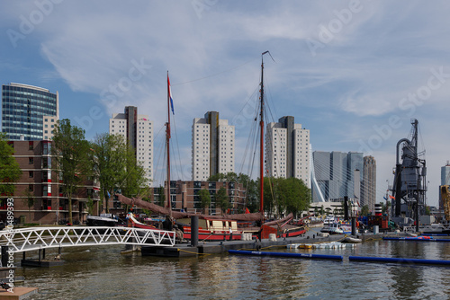 Outdoor sunny view surround with boats and ships at pier around leuvehaven and riverside of Nieuwe river in Rotterdam, Netherlands.  photo