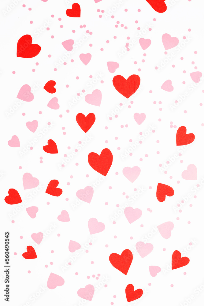 Flat lay Valentine's Day background made of red and pink hearts on white background. Valentine's Day creative concept. Top view, pattern.