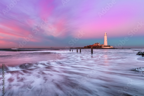 Lighthouse at sunset on the Northumberland coastline photo