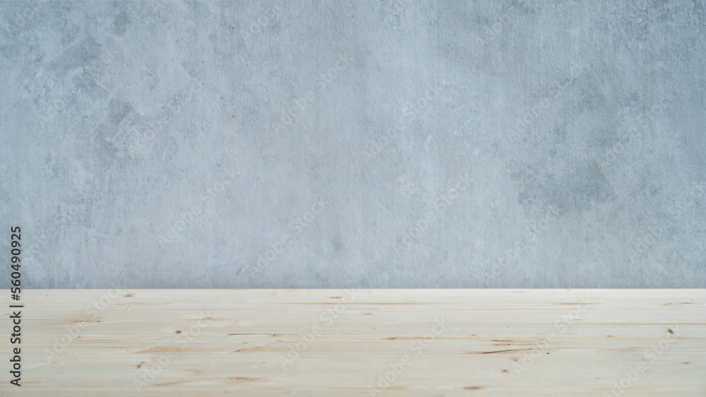 A light wooden table top with free space for installing a product or layout on a blue textured background. A light wooden table top with free space for installing a product or layout on a blue textured background.