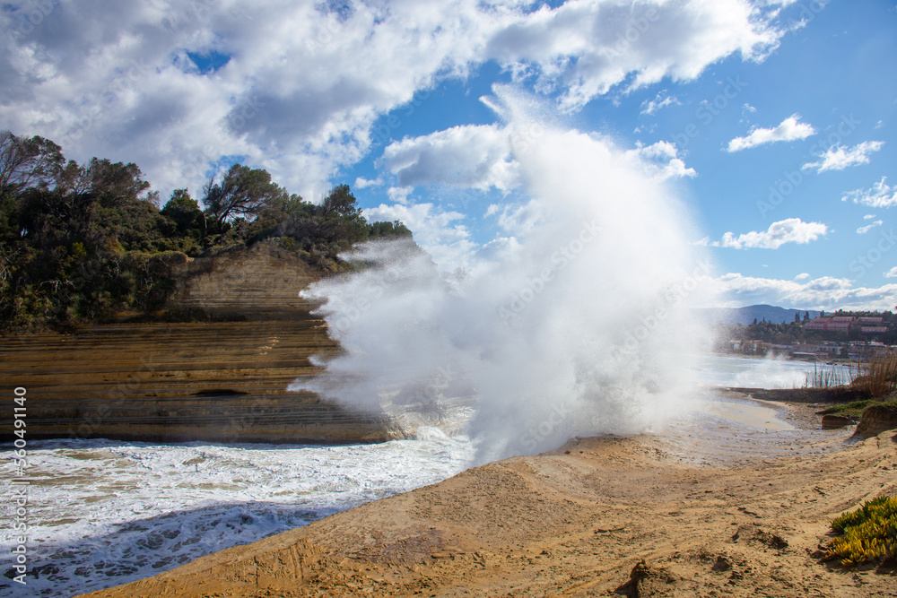 Cloudy and windy weather with large waves at the  beach in Peroulades, north Corfu island, Greece