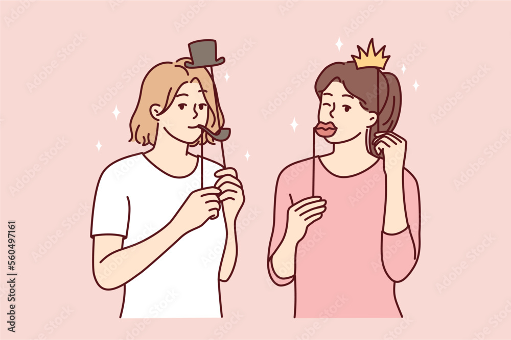 Girl friends with funny masks for photo shoot during house party or holiday carnival. Young casual women put cardboard lips and smoking pipe or crown with hat on their face. Flat vector illustration Girl friends with funny masks for photo shoot during house party or holiday carnival. Young casual women put cardboard lips and smoking pipe or crown with hat on their face. Flat vector illustration