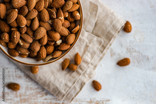Overhead view of a Bowl of almonds on a folded napkin