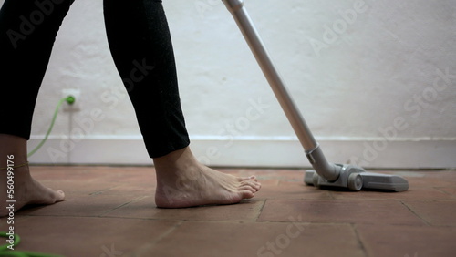 Person cleaning home with vacuum cleaner, woman cleans dirty floor corners3