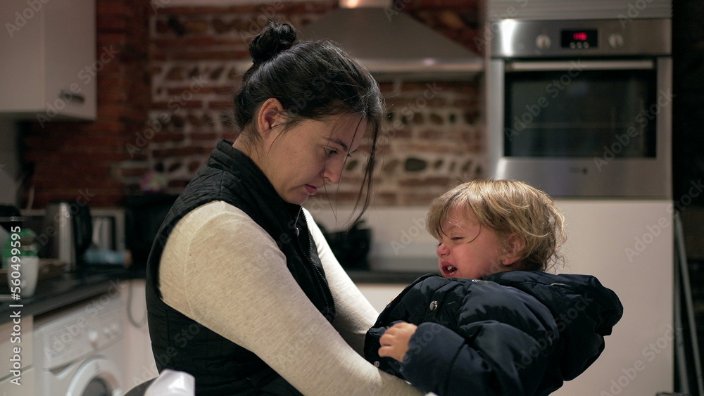 Mother consoling tearful crying baby toddler boy, casual and candid Mother consoling tearful crying baby toddler boy, casual and candid