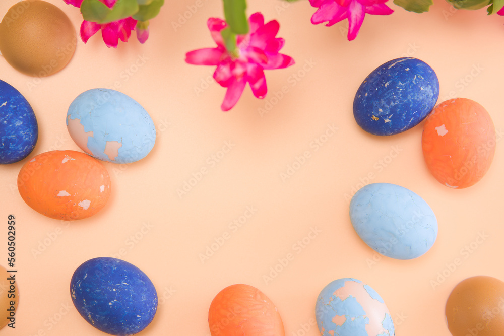 Copy space Easter colored eggs on a beige background. Blooming beautiful flower in the frame. mock-up Copy space Easter colored eggs on a beige background. Blooming beautiful flower in the frame. mock-up