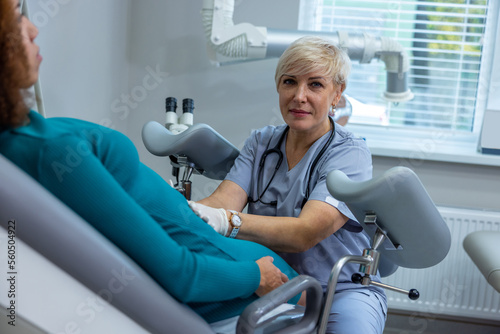 Curly-haired woman having an examination at the gynecologist office photo