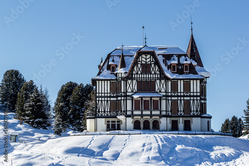 Riedalp, Switzerland - January 08. 2021: The famous Villa Cassel in winter. It was built in 1902 in Victorian architecture style and Sir Winston Churchill stayed here four times. photo