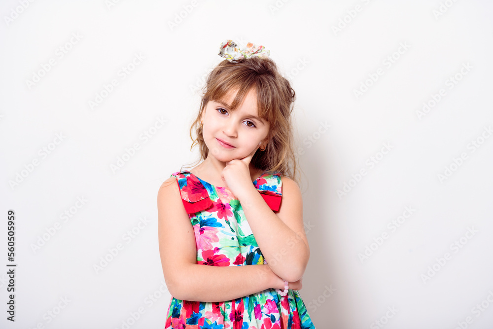 child girl in dress clothes on studio white