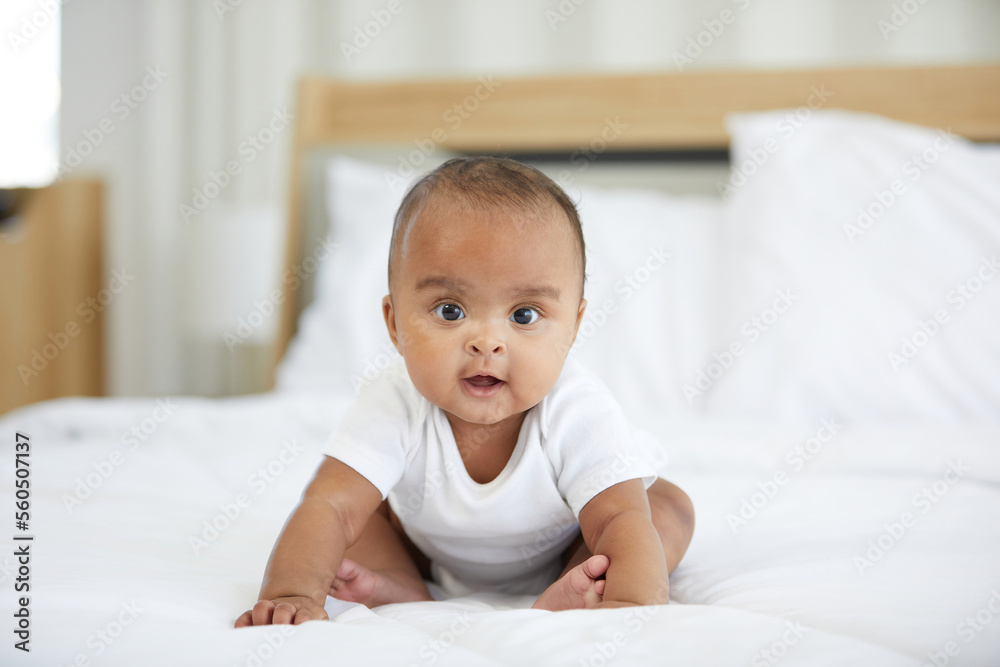African newborn baby sitting on bed at home African newborn baby sitting on bed at home
