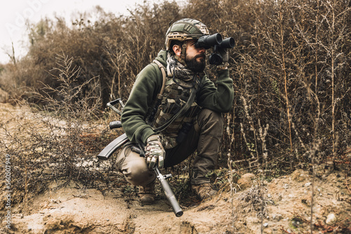 Soldier with binocular investigating the place