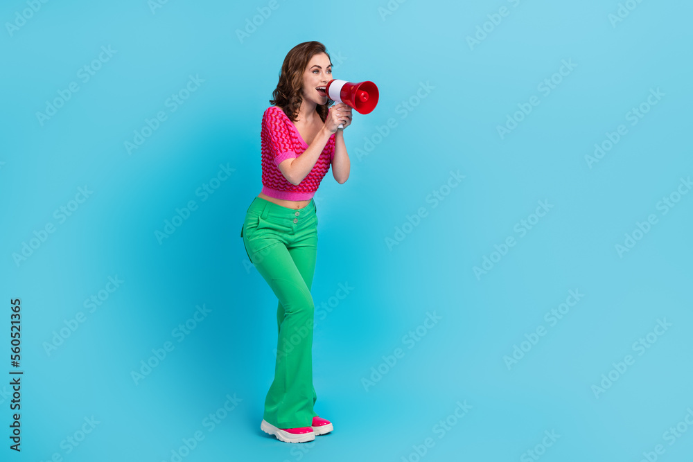 Full length photo of gorgeous lady wear stylish clothes say tell news special deal offer look empty space isolated on blue color background Full length photo of gorgeous lady wear stylish clothes say tell news special deal offer look empty space isolated on blue color background