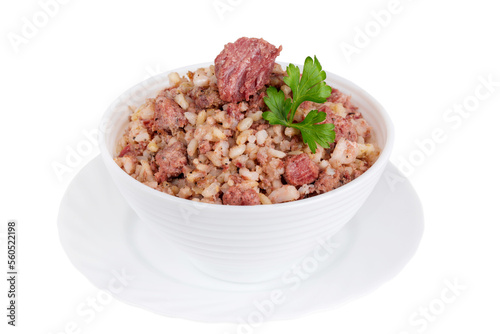 Canned rice porridge with meat and parsley in a bowl