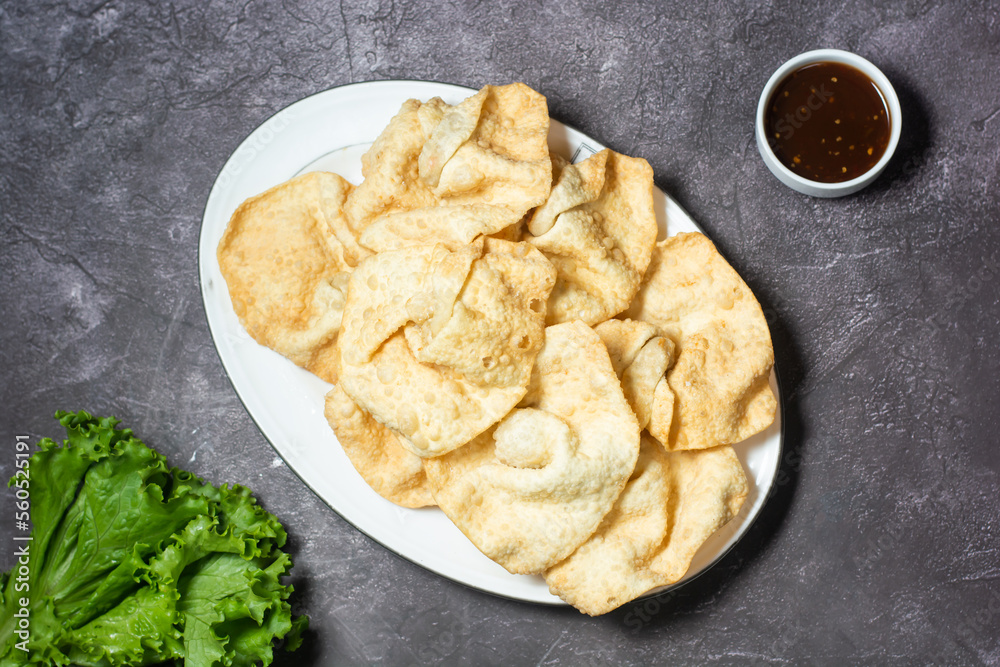 fried Wonton or woonthon and sauce served in dish isolated on grey background top view of indian and bangladesh food fried Wonton or woonthon and sauce served in dish isolated on grey background top view of indian and bangladesh food