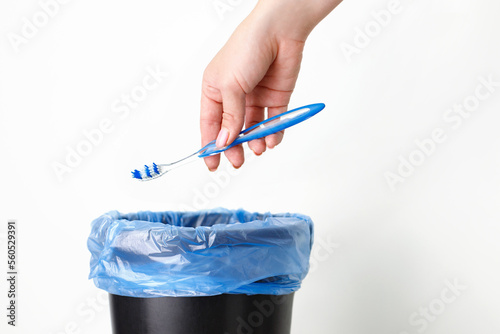 someone throws a toothbrush in the trash. garbage sorting photo