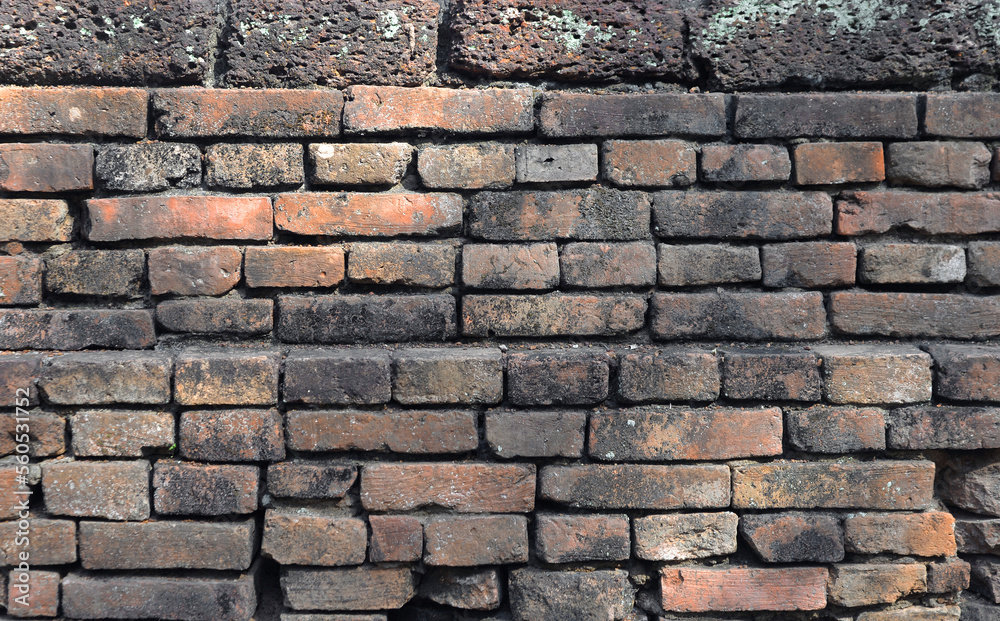 Fototapeta premium The orange old brick wall of the ancient building