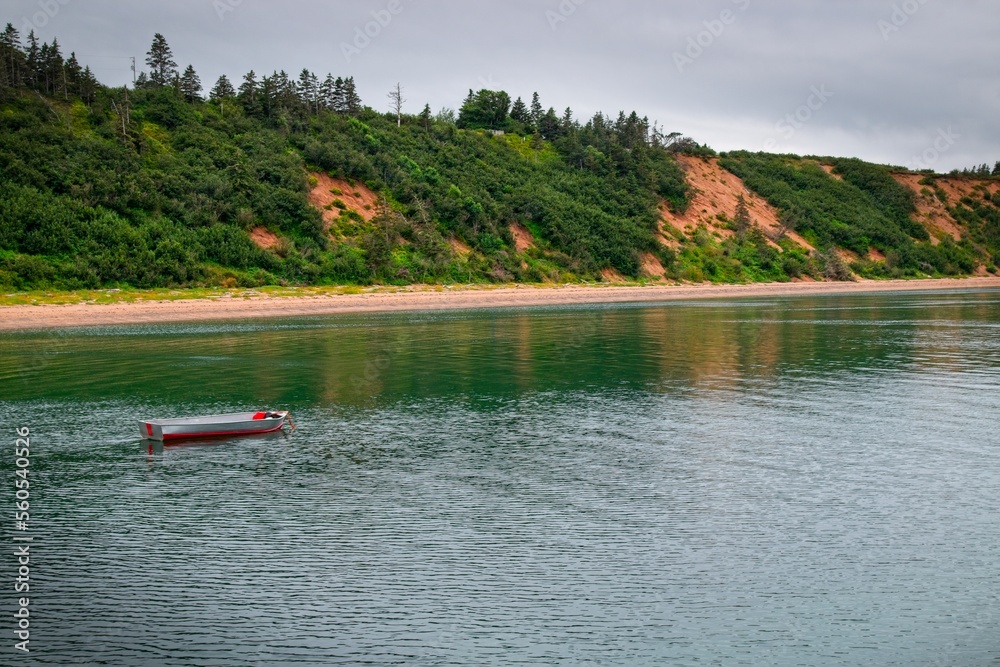 An aluminum boat anchored in a bay in Sandy Cove, Nova scotia.