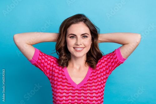 Photo of cheerful glad lady hold arms behind head completed task done finish work enjoy free time isolated on blue color background #560543163