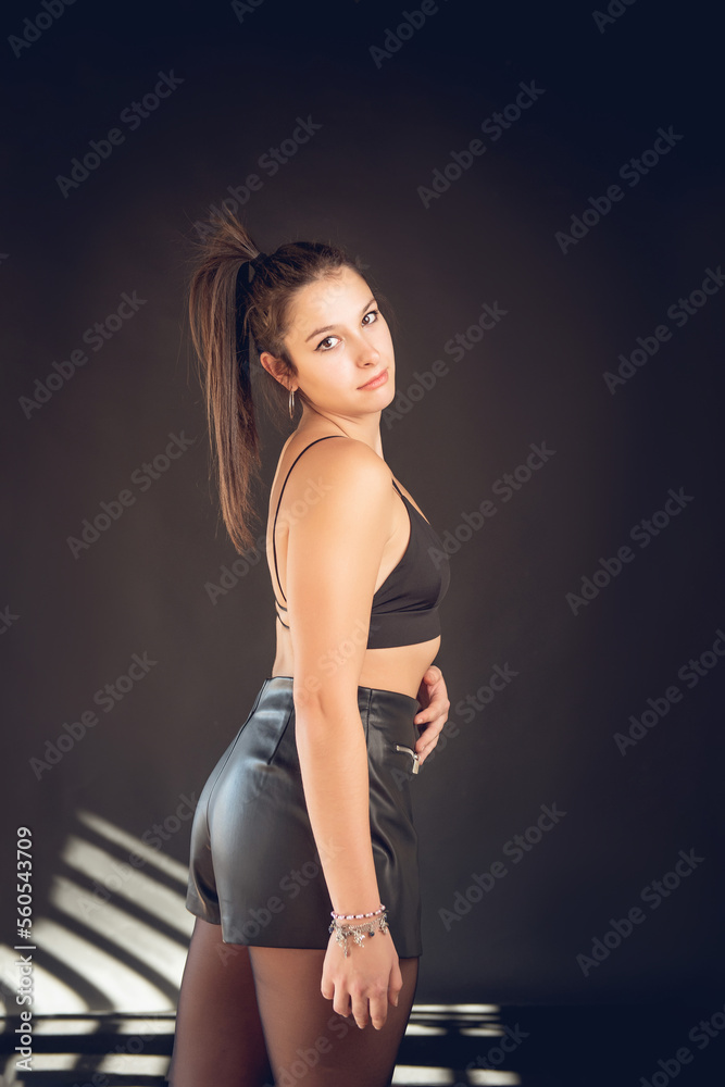 Vertical shot of a beautiful Caucasian woman posing in stylish clothes Vertical shot of a beautiful Caucasian woman posing in stylish clothes