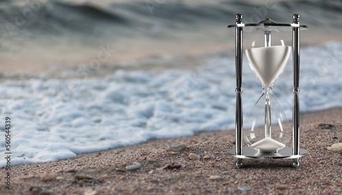 Vintage retro sand clock on sand beach. © BillionPhotos.com