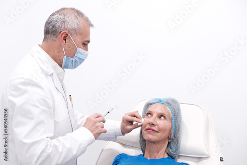 Horizontal picture of hand applying botox injection or acid hyaluronic to a woman