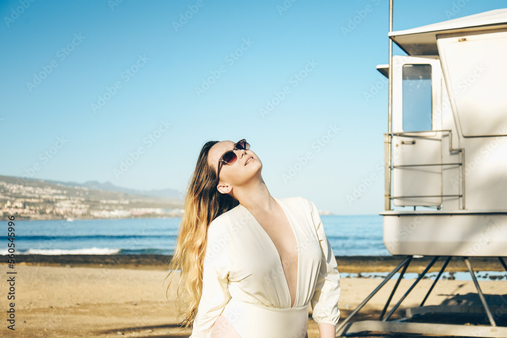 Summer, good emotions, woman smiling and laughing on a trip on the beach near the sea.